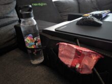 There is space for snacks and drinks on both sides.