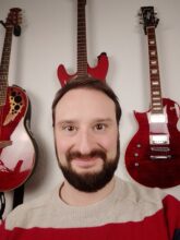 Man and guitars in the background