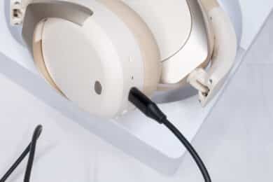 A USB cable connected to the USB port on the underside of the right ear cup