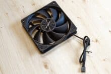 Black fan on a wooden table