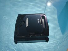 After work, the pool robot floats on the water.