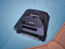 After work, the pool robot floats on the water.