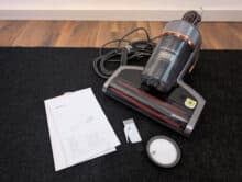 Jimmy BX7 Pro Max with mains cable, replacement filter, cleaning tool and operating instructions on carpet.
