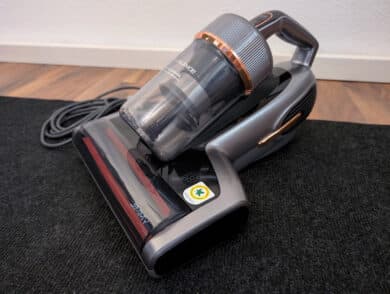 Jimmy BX7 Pro Max dust mite vacuum cleaner with cyclone container on carpeted floors.