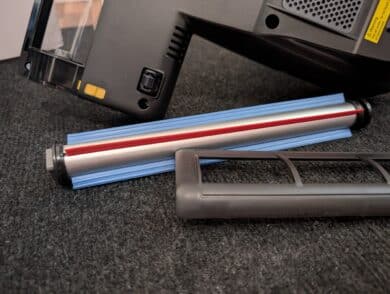 Removed brush roller with cover next to the appliance