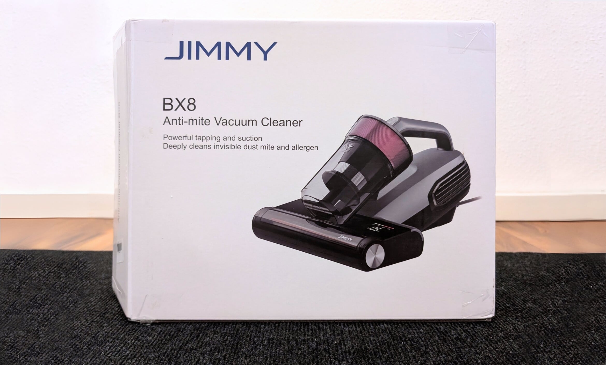 Packaging of the Jimmy BX8 dust mite vacuum cleaner with product image and model name.