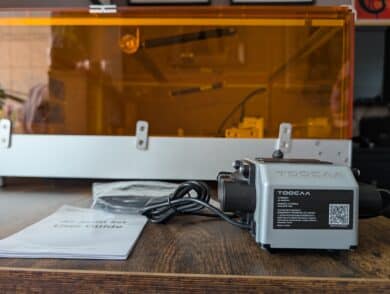 TOCOAA Air Assist pump with instructions in front of the closed laser housing.