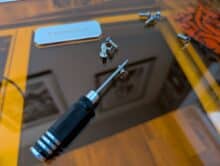 Screwdriver and screws on the Toocaa L2 - tools supplied on the acrylic flap during assembly