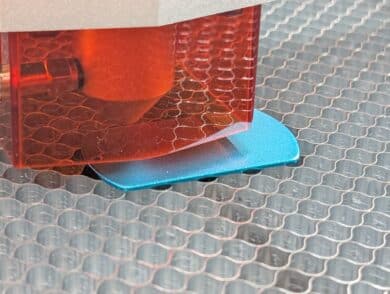 Laser head over blue dogtag - engraving process briefly interrupted