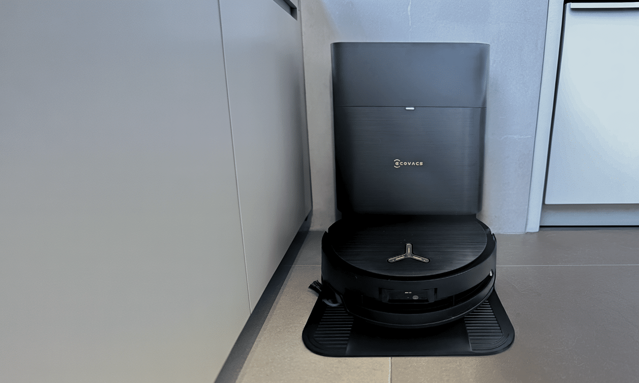 Ecovacs Deebot X9 Pro Omni robot vacuum on its compact all-in-one station in a modern kitchen