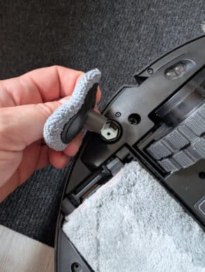 Hand holds the removable mini edge mop of the MOVA Z50 Ultra, showing easy maintenance and cleaning