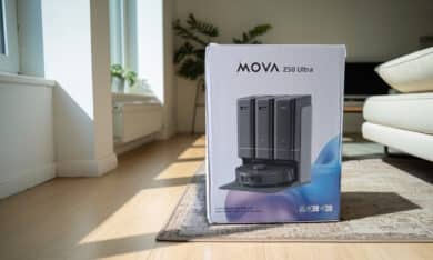 MOVA Z50 Ultra vacuum robot packing on living room carpet, showing black robot with station and HydroSync mopping roller technology