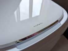 Glossy lid of the narwhal cleaning station with logo and touch bar