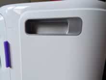 Recessed grip on the side of the narwhal cleaning station