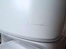 Discreet narwhal logo on the side of the cleaning station in cursive writing