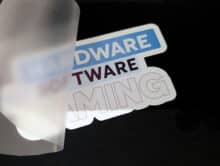 Partially removed backing film with the motif HARDWARE SOFTWARE GAMING on black fabric